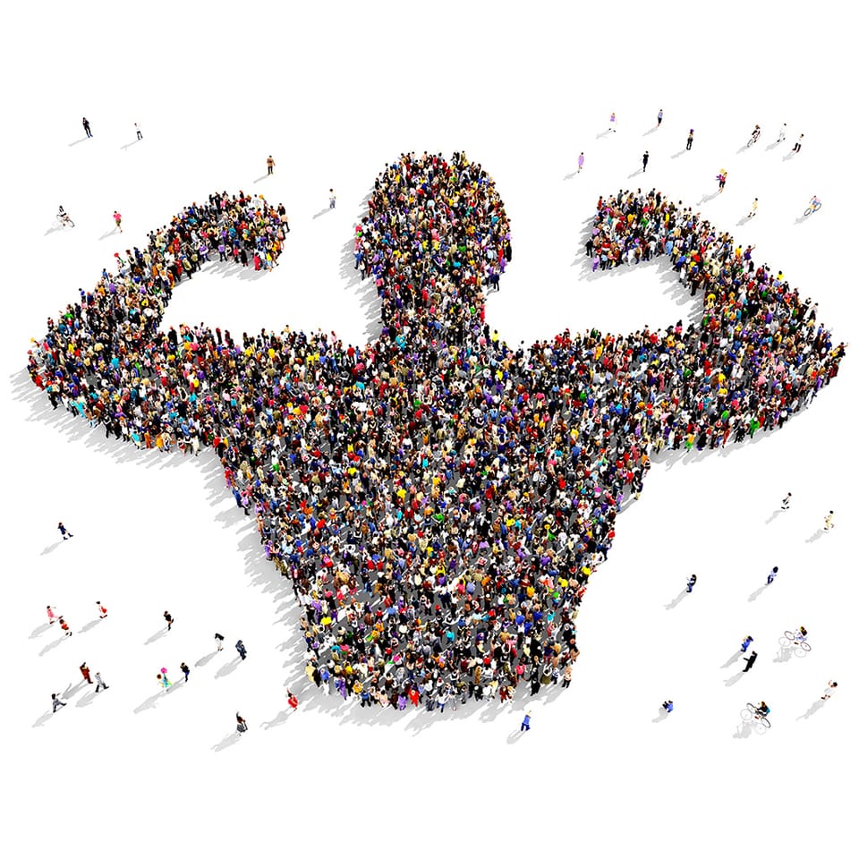 Hundreds of people photographed from above, standing together in the shape of a strong figure flexing both arms